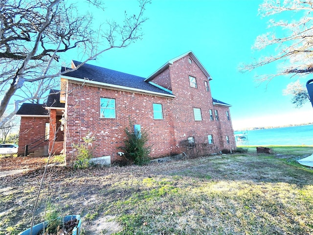 180 Shady Shores Dr, Mabank, TX 75156 - view of side of property with brick siding, roof with shingles, and a water view