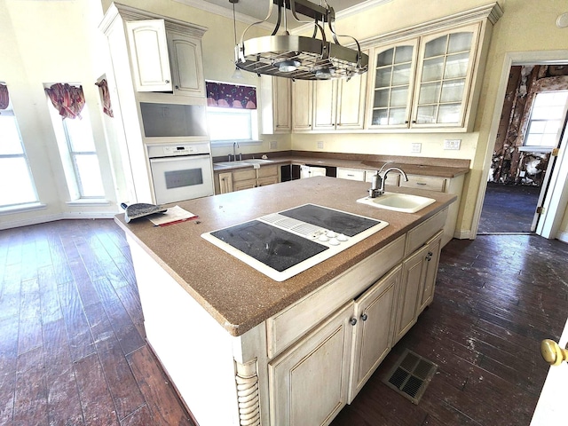 180 Shady Shores Dr, Mabank, TX 75156 - kitchen with a sink, white appliances, a chandelier, a center island with sink, and ornamental molding