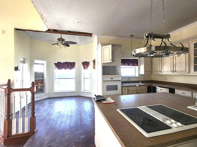 180 Shady Shores Dr, Mabank, TX 75156 - kitchen featuring white appliances, dark countertops, a sink, a textured ceiling, and dark wood-type flooring