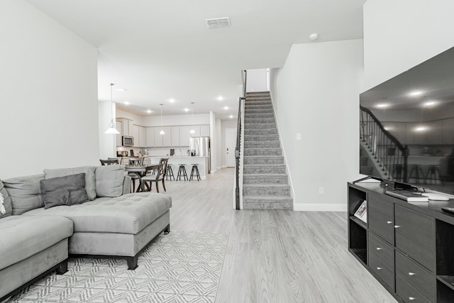 1302 Canyon Creek Rd, Wylie, TX 75098 - living area with stairs, light wood finished floors, baseboards, and recessed lighting