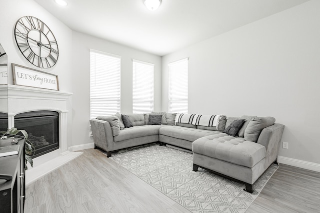 1302 Canyon Creek Rd, Wylie, TX 75098 - living area with wood finished floors, baseboards, a glass covered fireplace, and recessed lighting