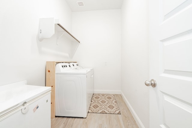 1302 Canyon Creek Rd, Wylie, TX 75098 - washroom featuring washing machine and dryer, light wood-style floors, and baseboards