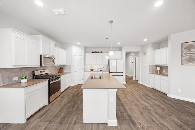 15532 Balham Pass, Fort Worth, TX 76247 - kitchen featuring appliances with stainless steel finishes, decorative backsplash, recessed lighting, a sink, and wood finished floors