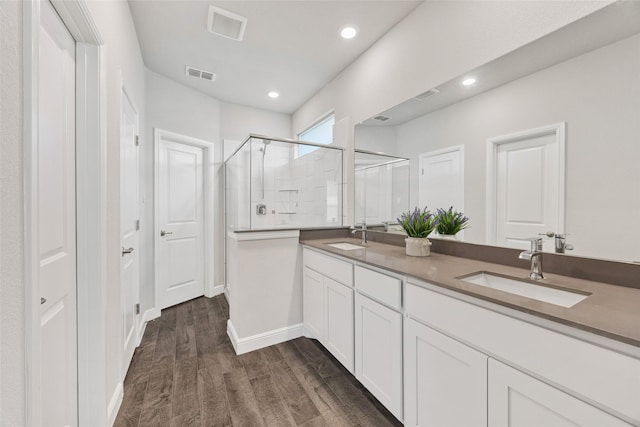 15532 Balham Pass, Fort Worth, TX 76247 - full bathroom featuring a stall shower, wood finished floors, double vanity, recessed lighting, and baseboards