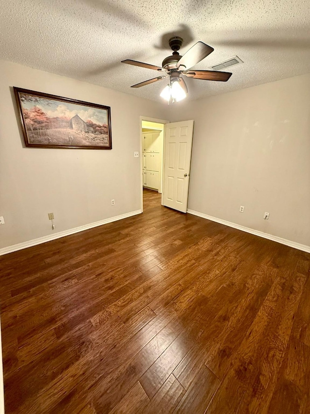 11535 Timber Ridge Dr, Keithville, LA 71047 - unfurnished bedroom with wood finished floors, baseboards, a textured ceiling, and a ceiling fan