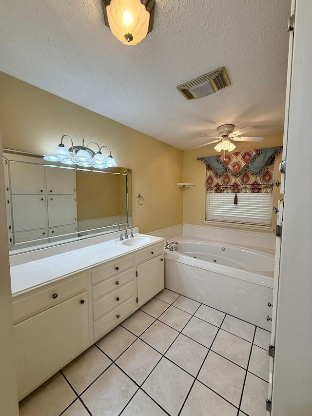 11535 Timber Ridge Dr, Keithville, LA 71047 - full bath featuring a tub with jets, tile patterned floors, vanity, a ceiling fan, and a textured ceiling