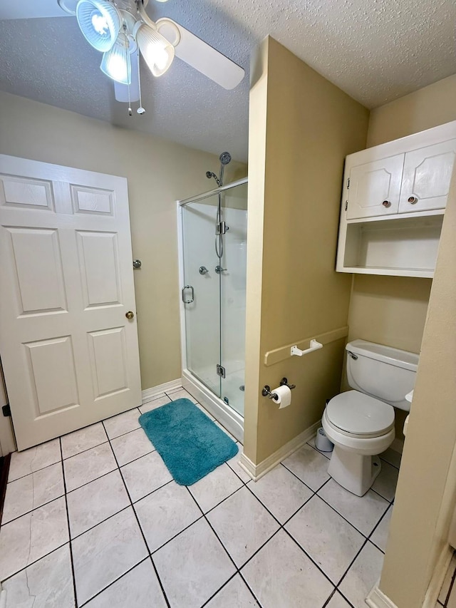 11535 Timber Ridge Dr, Keithville, LA 71047 - full bath with a shower stall, toilet, a textured ceiling, tile patterned flooring, and a ceiling fan