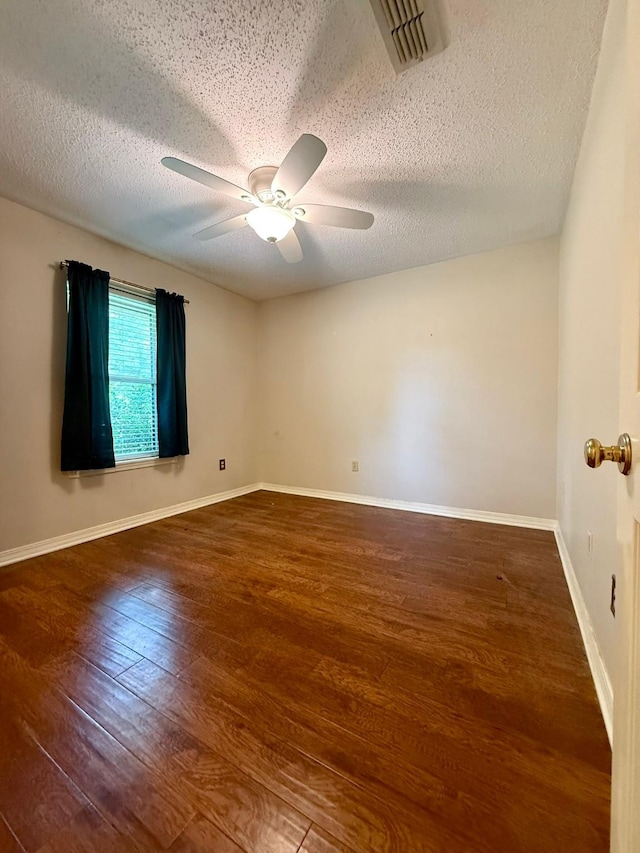 11535 Timber Ridge Dr, Keithville, LA 71047 - empty room with wood finished floors, a ceiling fan, a textured ceiling, and baseboards