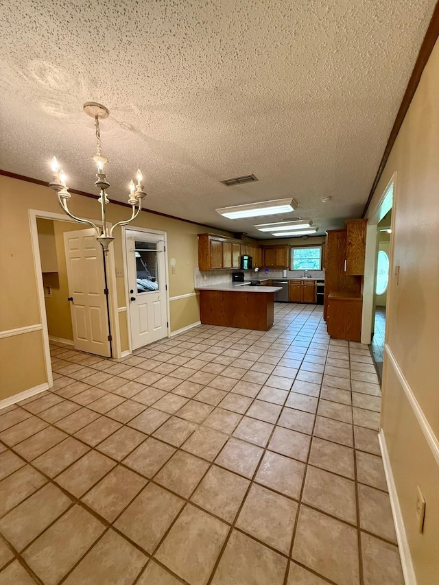 11535 Timber Ridge Dr, Keithville, LA 71047 - kitchen featuring a peninsula, a chandelier, a textured ceiling, light tile patterned flooring, and brown cabinetry