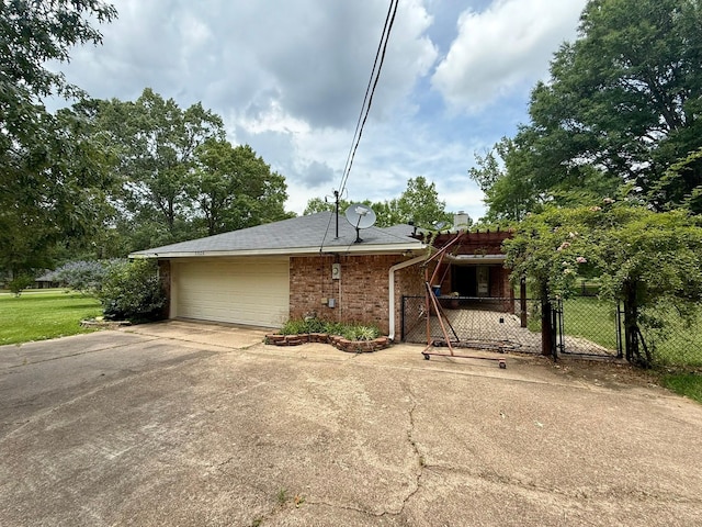 11535 Timber Ridge Dr, Keithville, LA 71047 - view of front facade with concrete driveway, a garage, a gate, brick siding, and a chimney