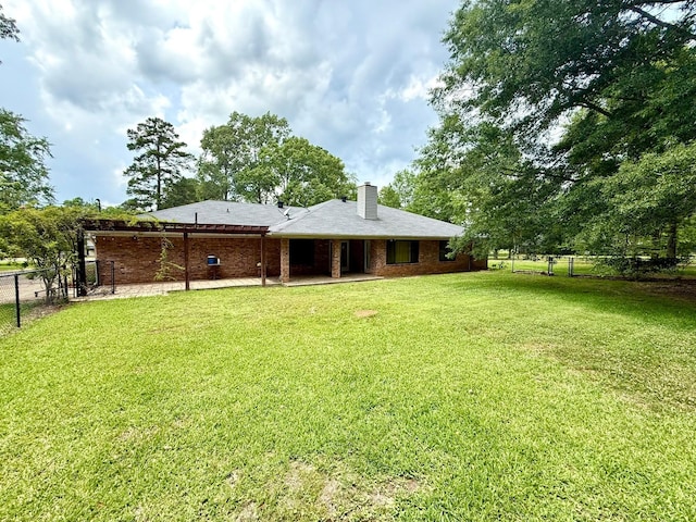 11535 Timber Ridge Dr, Keithville, LA 71047 - rear view of property with a chimney, a patio, and brick siding