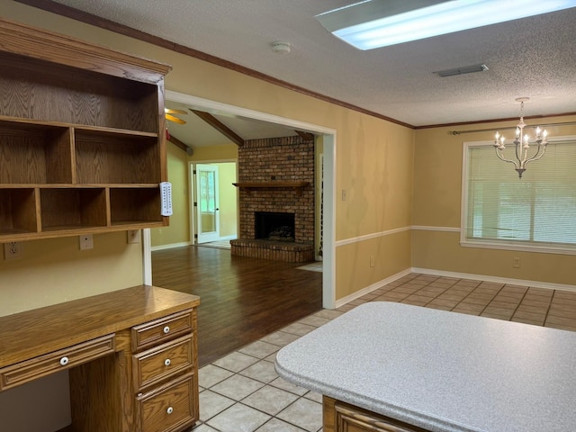 11535 Timber Ridge Dr, Keithville, LA 71047 - unfurnished living room featuring light tile patterned flooring, a chandelier, a fireplace, a textured ceiling, and a ceiling fan