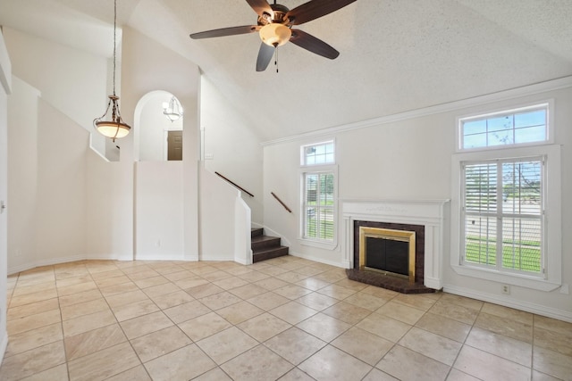 12848 Hilltop Dr, Balch Springs, TX 75180 - unfurnished living room featuring tile patterned flooring, high vaulted ceiling, a brick fireplace, stairway, and ceiling fan