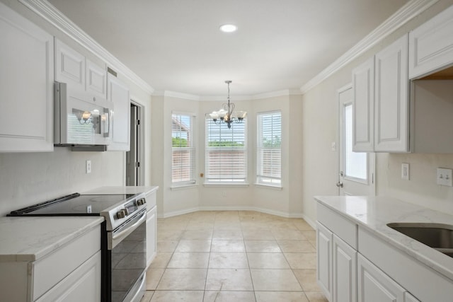 12848 Hilltop Dr, Balch Springs, TX 75180 - kitchen featuring white microwave, stainless steel range with electric cooktop, a chandelier, white cabinets, and recessed lighting