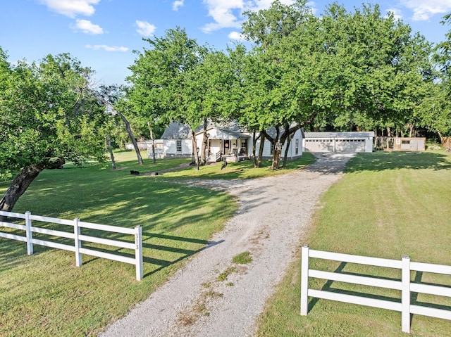 313 Chicken St, Weston, TX 75009 - view of property hidden behind natural elements featuring gravel driveway and a garage