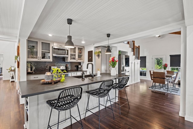 313 Chicken St, Weston, TX 75009 - kitchen with a sink, dark countertops, stainless steel appliances, dark wood-style floors, and recessed lighting