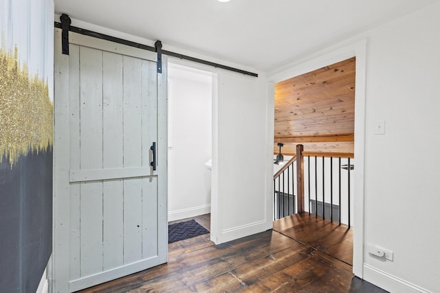 313 Chicken St, Weston, TX 75009 - unfurnished room with a barn door, hardwood / wood-style flooring, and baseboards