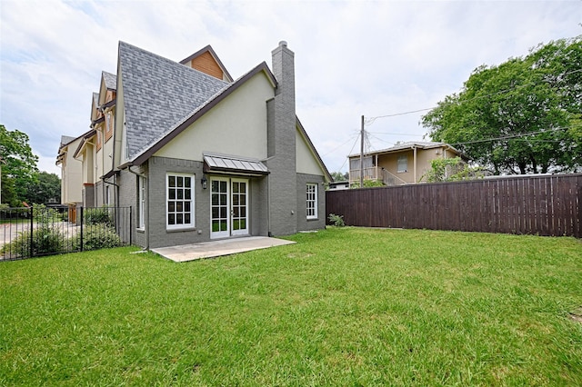 5067 Gaston Ave, Dallas, TX 75214 - back of house featuring a chimney, a shingled roof, a patio area, stucco siding, and a standing seam roof