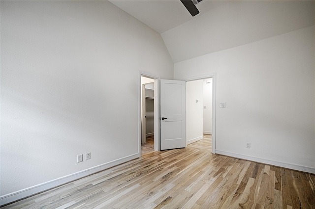 5067 Gaston Ave, Dallas, TX 75214 - unfurnished bedroom featuring vaulted ceiling, light wood-type flooring, a walk in closet, baseboards, and ceiling fan