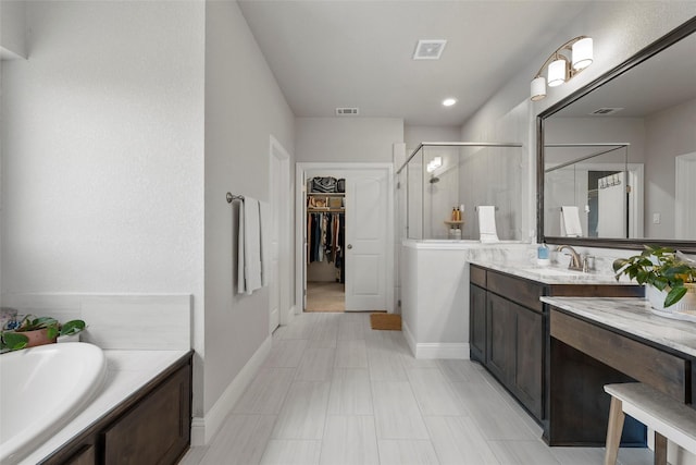205 Big Creek Loop, Hewitt, TX 76643 - bathroom with a stall shower, vanity, a walk in closet, baseboards, and a bath