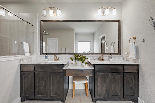 205 Big Creek Loop, Hewitt, TX 76643 - full bath featuring double vanity, a textured wall, tiled shower, and baseboards