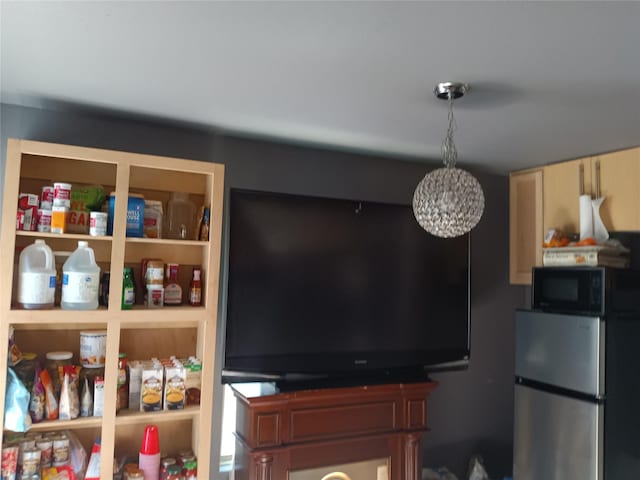 2911 S Denley Dr, Dallas, TX 75216 - detailed view of freestanding refrigerator and black microwave
