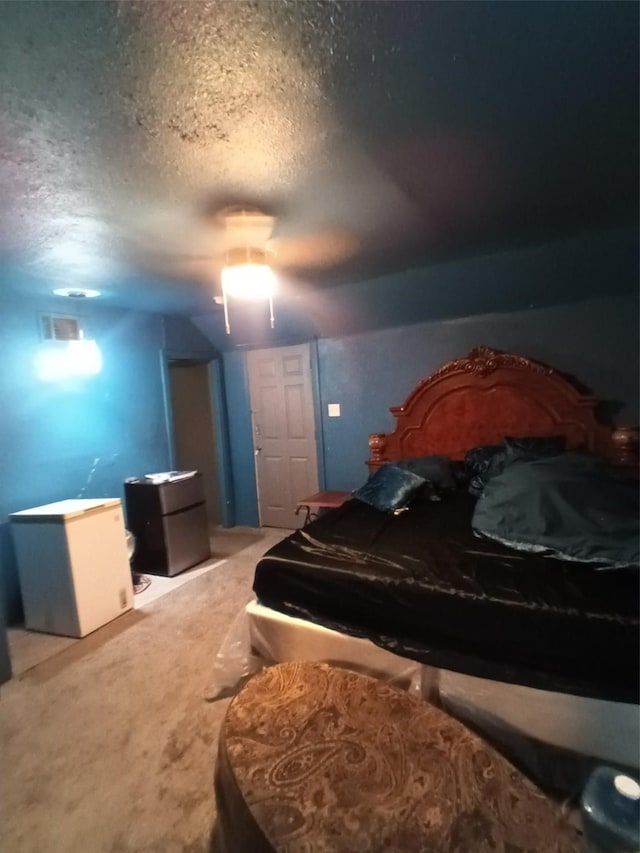 2911 S Denley Dr, Dallas, TX 75216 - carpeted bedroom with a textured ceiling, fridge, and a ceiling fan