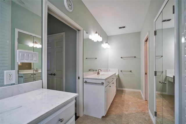 622 Green Meadow Trl, Holly Lake Ranch, TX 75765 - full bathroom with two vanities, tile patterned flooring, and baseboards
