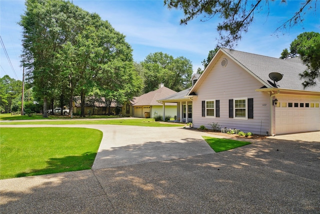 622 Green Meadow Trl, Holly Lake Ranch, TX 75765 - view of front of house with asphalt driveway, a front lawn, a garage, and a shingled roof