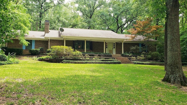 401 S Timberlane, Lone Star, TX 75638 - ranch-style house with a front lawn, a chimney, and brick siding