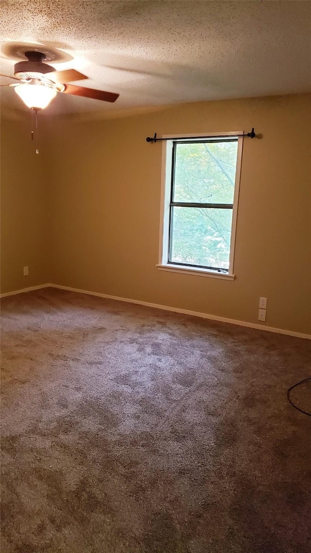 401 S Timberlane, Lone Star, TX 75638 - carpeted spare room with a textured ceiling, baseboards, and ceiling fan