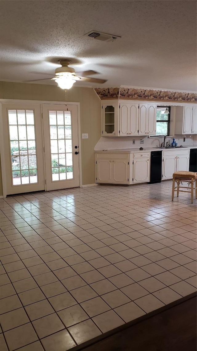 401 S Timberlane, Lone Star, TX 75638 - kitchen featuring a textured ceiling, a ceiling fan, plenty of natural light, white cabinetry, and light tile patterned floors