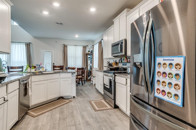 5725 Miriam Dr, Forney, TX 75126 - kitchen featuring stainless steel appliances, light wood-style flooring, white cabinets, stone counters, and recessed lighting