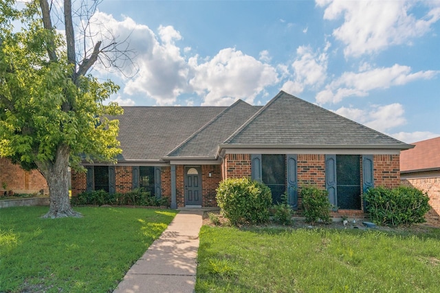 2209 Country Oaks Dr, Garland, TX 75040 - view of front facade with brick siding, a front lawn, and a shingled roof