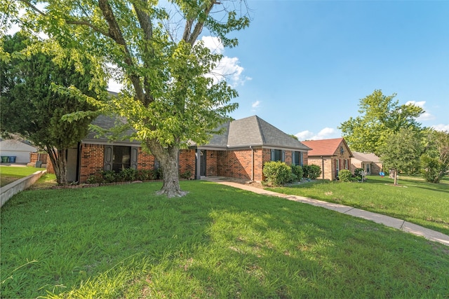 2209 Country Oaks Dr, Garland, TX 75040 - view of front of house featuring brick siding, a front lawn, and roof with shingles