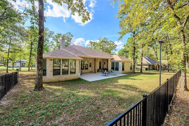 126 Saint Andrews Dr E, Mabank, TX 75156 - back of property featuring a patio area, brick siding, a chimney, and roof with shingles