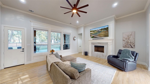 126 Saint Andrews Dr E, Mabank, TX 75156 - living area with ceiling fan, light wood-style flooring, a high end fireplace, recessed lighting, and crown molding