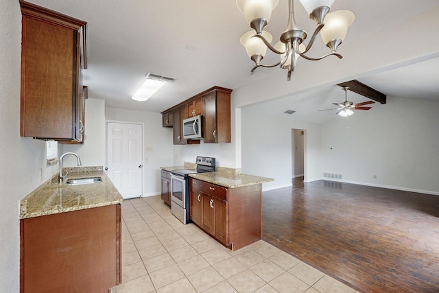 6432 Melinda Ct, Watauga, TX 76148 - kitchen featuring appliances with stainless steel finishes, a sink, light stone countertops, a ceiling fan, and a chandelier
