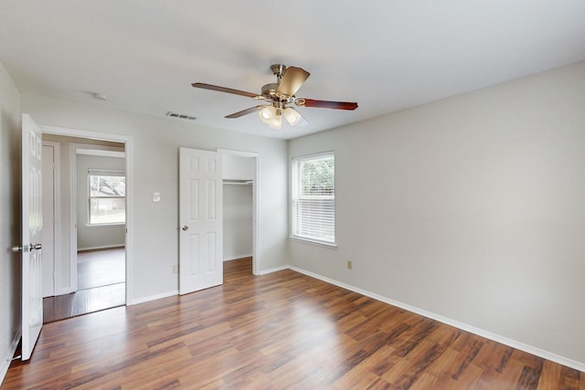 6432 Melinda Ct, Watauga, TX 76148 - unfurnished bedroom with wood finished floors, baseboards, a closet, and ceiling fan