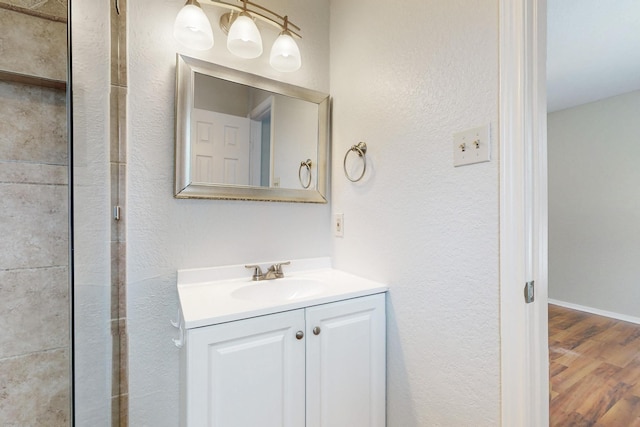 6432 Melinda Ct, Watauga, TX 76148 - bathroom with vanity, wood finished floors, and a textured wall