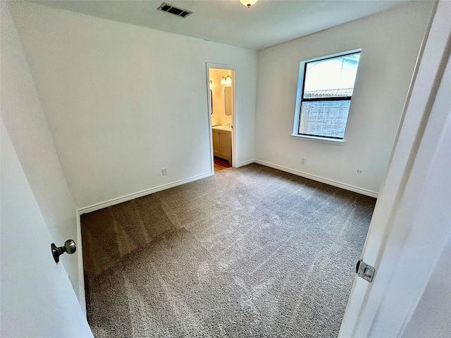 3913 Longstraw Dr, Fort Worth, TX 76137 - unfurnished bedroom featuring dark carpet, ensuite bath, and baseboards