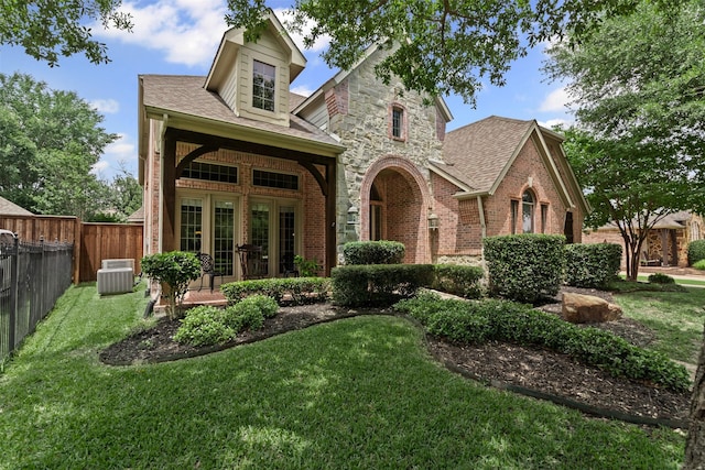 2505 Shoreline Dr, Keller, TX 76248 - view of front of property featuring brick siding, central air condition unit, a shingled roof, and french doors