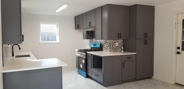 412 Ellis St, Allen, TX 75002 - kitchen featuring stainless steel gas range oven, a sink, under cabinet range hood, and light marble finish flooring