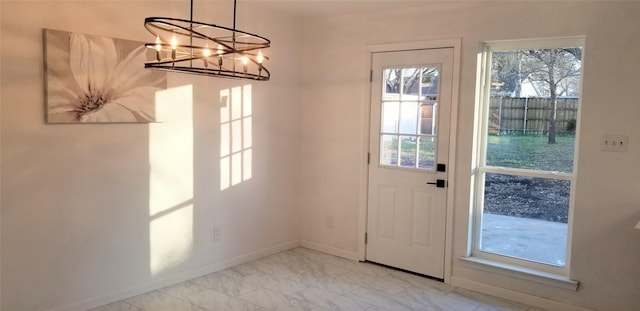 412 Ellis St, Allen, TX 75002 - doorway with baseboards, light marble finish flooring, and a chandelier