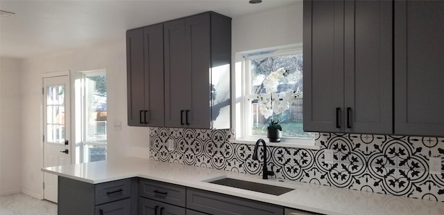 412 Ellis St, Allen, TX 75002 - kitchen featuring a sink, gray cabinets, light countertops, and tasteful backsplash