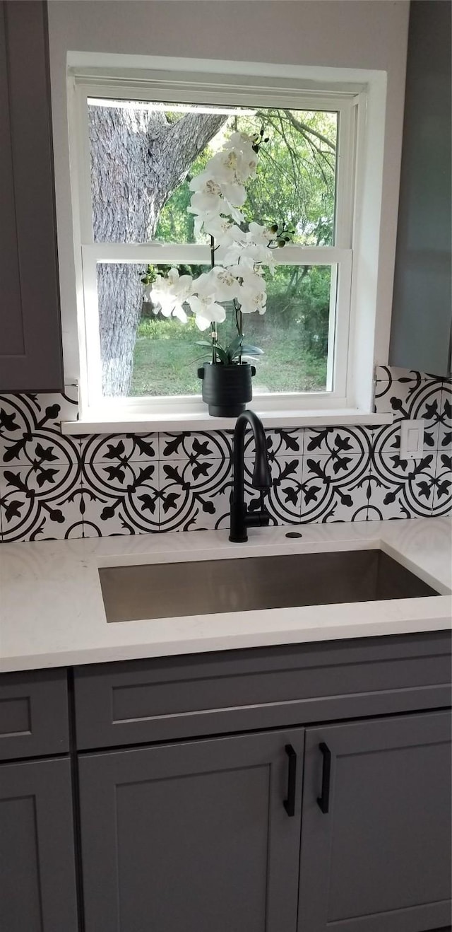 412 Ellis St, Allen, TX 75002 - detailed view of gray cabinetry, a sink, and light countertops