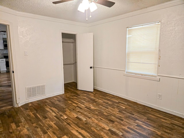 1155 Clay St, Canton, TX 75103 - unfurnished bedroom featuring a textured ceiling, dark wood-style flooring, and a ceiling fan