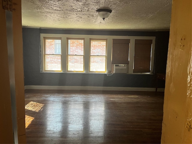 544 N Clinton St, Stephenville, TX 76401 - empty room featuring wood-type flooring, a textured ceiling, baseboards, and cooling unit