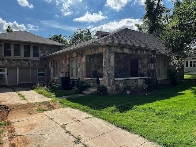 544 N Clinton St, Stephenville, TX 76401 - view of side of property with stone siding and a lawn