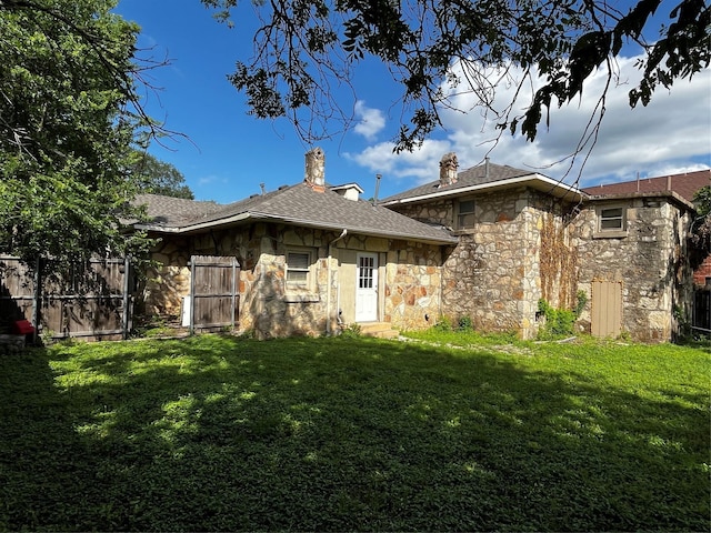 544 N Clinton St, Stephenville, TX 76401 - rear view of property featuring stone siding and a chimney